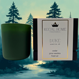 Green candle and packaging with 'Regal Home Fragrance' on a forest background