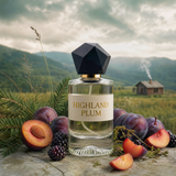 A perfume bottle labeled 'HIGHLAND PLUM' sits on a stone surface surrounded by plums, sliced fruit, and dark berries, with a blurred mountain landscape and small cabin in the background.